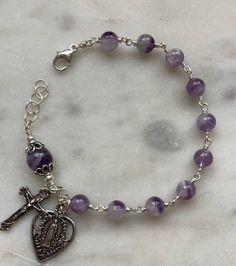 Catholic Rosary Bracelet: 6 and 8mm amethyst bracelet   Solid sterling silver wire, clasp, chain and medals. Amethyst 8mm Beads Jewelry Gift, Purple Wire Wrapped Bracelet, Wire Wrapped Amethyst Bracelets In Purple, Wire Wrapped Purple Amethyst Bracelets, Handmade Adjustable Amethyst Sterling Silver Bracelet, Wire Wrapped Amethyst Bracelet, Purple Amethyst Wire Wrapped Bracelets, Purple Wire Wrapped Bracelets As Gift, Spiritual Adjustable Bracelet With Lobster Clasp