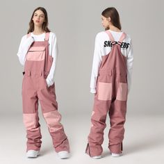 two women in overalls standing next to each other on a gray background, one wearing pink pants and the other white shirt