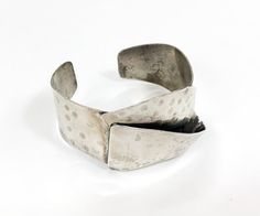 "~ 1970s nice quality wide silver bracelet ~ Hammered silver look cuff ~ Folded over band ~ Unmarked and probably an alloy ~ Very nice Width- 1.5\" (3.81 cm) More Incredible Jewelry: glennasvintageshop.etsy.com Additional Vintage in our sister shop Glenna's Jewels: glennasjewels.etsy.com Instagram @glennas_clothing Facebook https://www.facebook.com/glennasclothing" Silver Hand Cast Metal Cuff Bracelet, Silver Metal Cuff Bracelet Hand Cast, Vintage Hand Cast Cuff Bangle Bracelet, Vintage Hand Cast Bangle Cuff Bracelet, Vintage Hand Cast Cuff Bangle, Silver Metal Modernist Cuff Bracelet, Modernist Silver Metal Cuff Bracelet, Modernist Metal Cuff Bangle, Vintage Metal Wide Band Bracelets