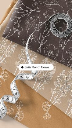 an assortment of wrapping paper with flowers and measuring tape on them, including the words birth month flows