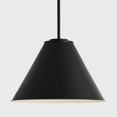 a black lamp hanging from the ceiling with a white light on it's side