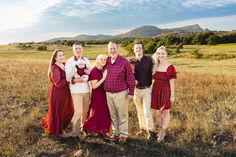 a group of people standing next to each other in a field