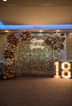 the entrance to an event is decorated with lights and balloons, as well as a large number