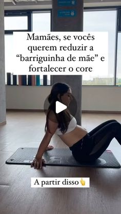 a woman is sitting on a yoga mat