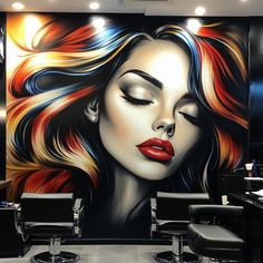 a painting of a woman's face is on the wall next to salon chairs