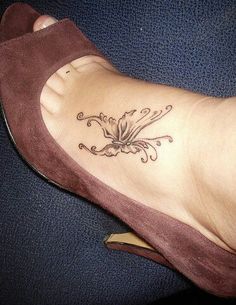 a woman's foot with a flower tattoo on it