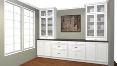 an empty kitchen with white cabinets and black counter tops, along with wood flooring