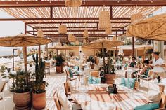 an outdoor dining area with tables and umbrellas