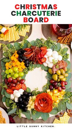 christmas charcuterie board with grapes, olives, and other fruits on it