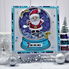 a snow globe card with santa clause on it