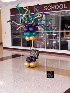 a balloon tree in the middle of a school lobby