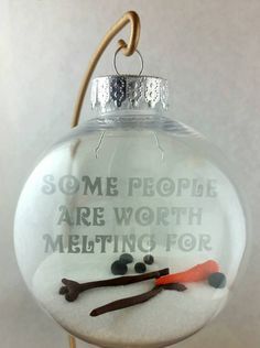 a glass ornament with some people are worthing for something to do on it