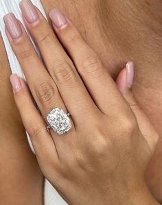 a woman's hand with a diamond ring on it