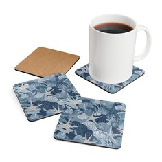 a cup of coffee and coasters on a white background