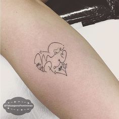 a small tattoo on the arm of a woman with an elephant and flowers in it