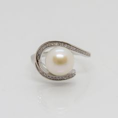 Vintage Sterling Silver White Pearl & White Topaz Ring...Marked 925...Total of weights 4.3grams... Size 9...Measure of Face 13.3MM...It's in very good condition. Anniversary Sterling Silver Pearl Ring With Diamond Accents, Sterling Silver Pearl Ring With Diamond Accents, Fine Jewelry Sterling Silver Pearl Ring With Diamond Accents, Silver Hallmarked Round Cut Pearl Ring, Sterling Silver Bypass Ring For Formal Events, Classic Sterling Silver Round Bypass Ring, Classic Round Sterling Silver Bypass Ring, Formal Round Pearl Ring Stamped 925, White Gold Pearl Ring Stamped 925