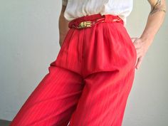 "Vintage knickerbockers high waist pants - Jean Claude Made in France 1970s Red pants with grey and gold stripes. Pleated at the waist. Knee length. Puffy legs with button on bottom. High waist with 2 buttons / zip closure . Braided belt in the same colores with gold buckle. 2 side pockets. In perfect condition. Size : FR36 US4 UK6 Our model wears usually a size S (UE36/38) and is 170cm/66,9\" tall. Measurements (flat): Waist: 30cm - 11,8\" Hips: 53cm - 20,8\" Front crotch: 35cm - 13,7\" Back cr Vintage Summer Pants With Belt Loops, Retro Red High-waisted Pants, Retro Red Bottoms For Spring, Vintage Red Wide Leg Pants, Vintage Red Fitted Bottoms, Vintage Fitted Bottoms With Elastic Waistband, Retro Red Trousers, Red Fitted Vintage Bottoms, Retro High-waist Bottoms With Elastic Waistband