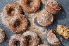 powdered doughnuts and muffins on a blue surface