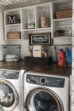 a washer and dryer in a room with open shelving on the wall