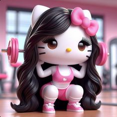 a hello kitty figurine is sitting on the floor with a barbell in her hand