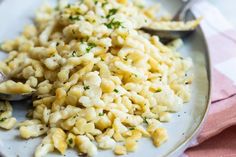 macaroni and cheese on a plate with spoons