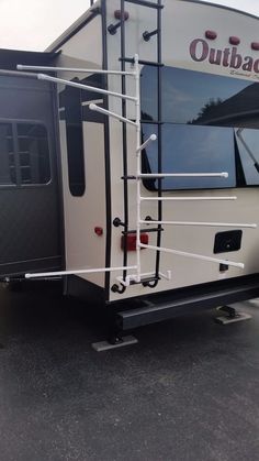 an outback camper parked in a parking lot