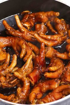 chicken wings are being cooked in a pan