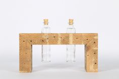 two empty glass bottles sitting on top of a wooden table