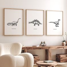 three framed dinosaurs in black and white on a wall above a chair, coffee table with two end tables