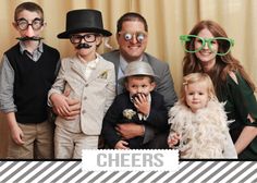 a group of people standing next to each other with fake mustaches on their heads