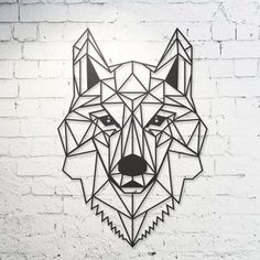 a geometric wolf head on a white brick wall