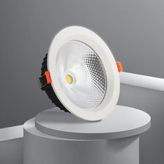 an image of a dim downlight on top of a white pedestal in the middle of a room