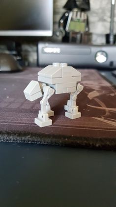 a lego star wars at - at is sitting on top of a mouse pad