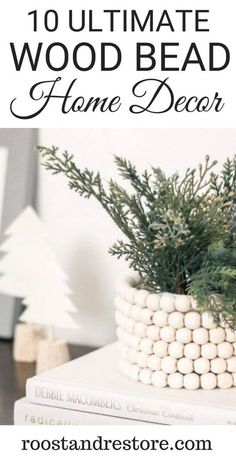 a white basket filled with wooden beads and greenery on top of a stack of books