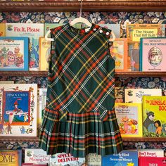 Description: Vintage 1970s Girls' Green and Red Plaid Pleated Drop Waist Dress Condition: Good Size: Size 7 Measurements:  Pit to Pit : 14" Total Length : 25" Plaid A Line Dress, Plaid Fall Dress, 70s Catalog Fashion, Retro Fitted School Dress, Retro Fitted Dress For School, Sleeveless Vintage Dress For Fall, Plaid Dress Outfit, Plaid Clothing, Eclectic Outfits