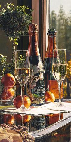 three bottles and two glasses sitting on a table