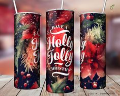 three christmas themed tumblers sitting on top of a wooden table