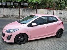 a pink car is parked on the street