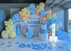 balloons and decorations on a table at a children's birthday party in a garage