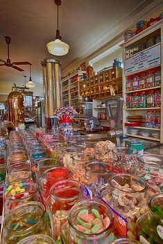 a store filled with lots of different types of candies and candy in glass jars