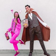 a man and woman dressed up in costumes posing for a photo with one holding a book