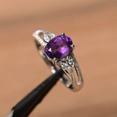 It is a natural amethyst ring. The main stone is 6 mm*8 mm oval cut.weight about 1.14 carats.The basic metal is sterling silver and plated with rhodium.To change the metal to a solid gold (white/rose) or platinum is also available, please ask for a quotation if you want.You can also go to my shop Home for more elegant rings: https://www.etsy.com/shop/godjewelry?ref=hdr_shop_menu Amethyst is the February birthstone .More amethyst rings:https://www.etsy.com/shop/godjewelry?section_id=20709248Custo Amethyst Rings, Elegant Rings, Ring Purple, February Birthstone, Elegant Ring, February Birth Stone, Amethyst Ring, Promise Ring, White Rose