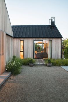 a house that has some plants in front of it