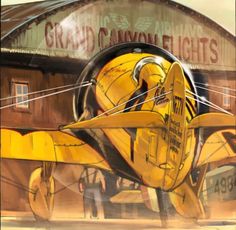 a painting of a yellow airplane in front of a building