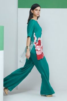 Green three fourth sleeves boat neck silk top with red and white floral gardenia applique detailing. Paired with a solid green bootcut flare pant. - Aza Fashions Spring Silk Sets With Straight Pants, Silk Sets With Straight Pants For Spring, Summer Silk Sets With Wide Leg, Applique Top, Pant For Women, Flare Pant, Solid Green, Bootcut Pants, Green Top