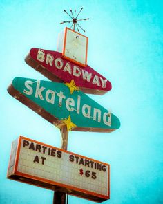 a street sign with the name broadway and skateland painted on it's sides