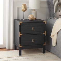 a night stand with two drawers and a lamp on the end table next to it