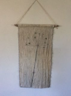 a wall hanging with a dandelion on it