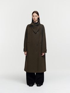 Displayed is a long, dark-toned overcoat featuring a turtleneck sweater underneath. The coat has a classic straight cut with a clean and elegant line, complete with a visible button placket down the front. There are patch pockets on either side, and the sleeves are finished with adjustable straps, possibly with buttons.- The coat's design, with its high neck coverage, suggests it is intended for wear in colder weather.- The dark fabric and simple design give the coat a versatile look that could be suitable for both formal and casual occasions.- Its length appears to be mid to long, providing substantial coverage and warmth. High Neck Coat, Dark Fabric, Coat Design, Straight Cut, Long Coat, Turtleneck Sweater, Simple Design, Cold Weather, Simple Designs