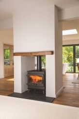 a wood burning stove sitting inside of a living room